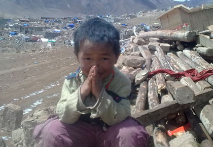 A young girl bemused by the destruction around her. Yushu Earthquake, seven days on